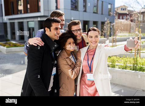 happy people with conference badges taking selfie Stock Photo - Alamy