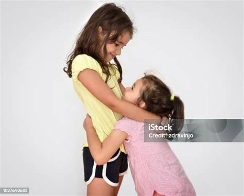 Two Hugging Sisters Stock Photo - Download Image Now - Beautiful People, Beauty, Cheerful - iStock