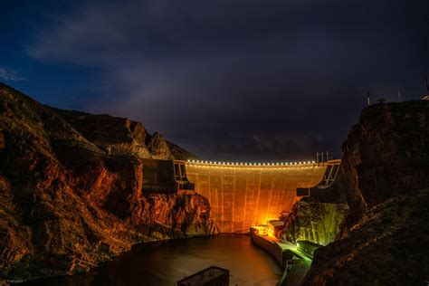 a large dam at night with the lights on