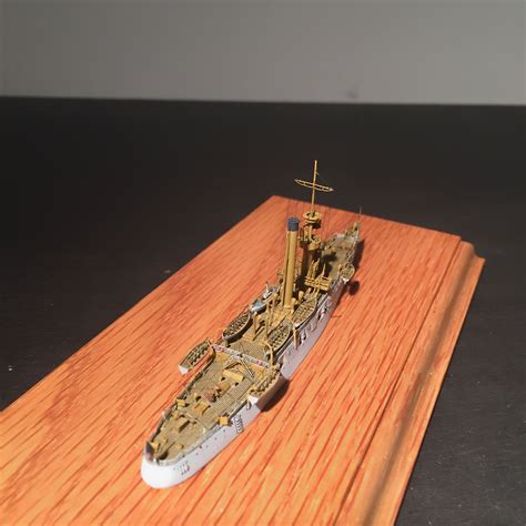 a model ship is sitting on a wooden board