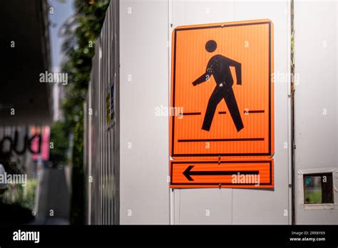 Pedestrian crossing sign under construction with orange color Stock Photo - Alamy