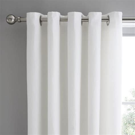 Mini Waffle White Blackout Eyelet Curtains | Dunelm