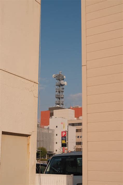 Transmission Tower above Building · Free Stock Photo