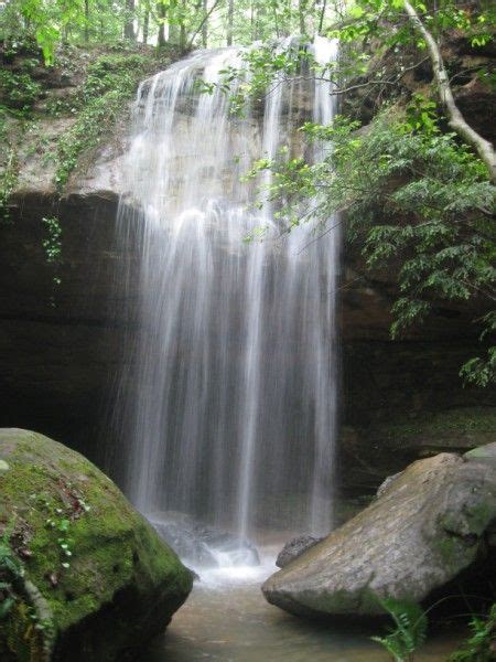 there is a waterfall in the middle of some rocks