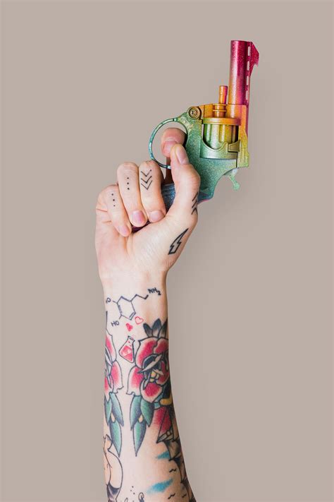 Hand with tattoo holding gun | Premium PSD - rawpixel