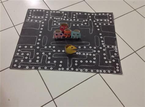 Pacman board-game. Game board made with black cartridge paper and reinforcer, as well as chalk ...