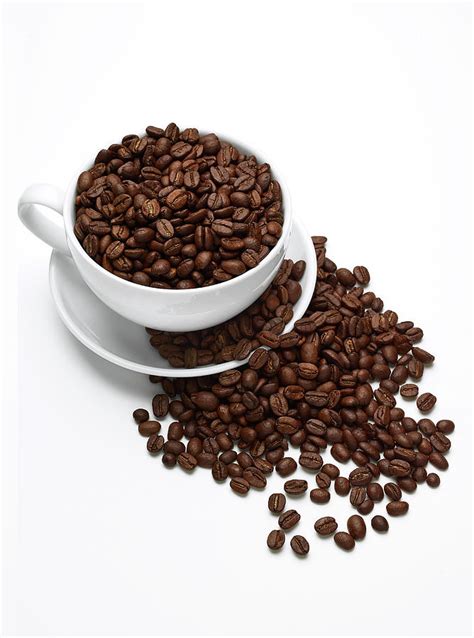 Coffee Beans In Coffee Cup On White by Ts Photography