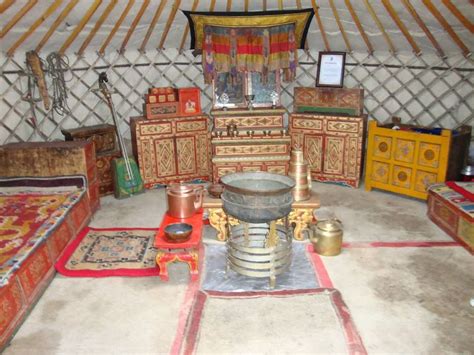 the interior of a yurt with many items in it and rugs on the floor