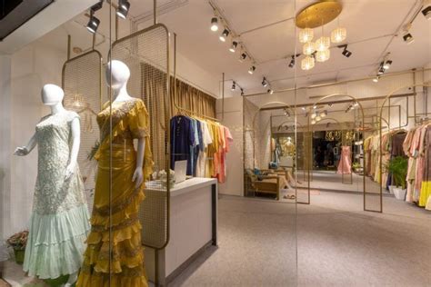 a clothing store with mannequins and dresses on display in front of mirrors