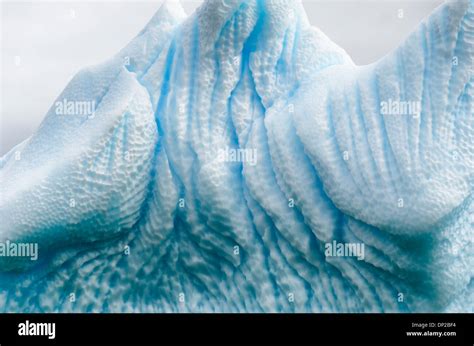 ANTARCTICA - Intricate shapes carved into an Antarctic iceberg floating near Two Hummock Island ...