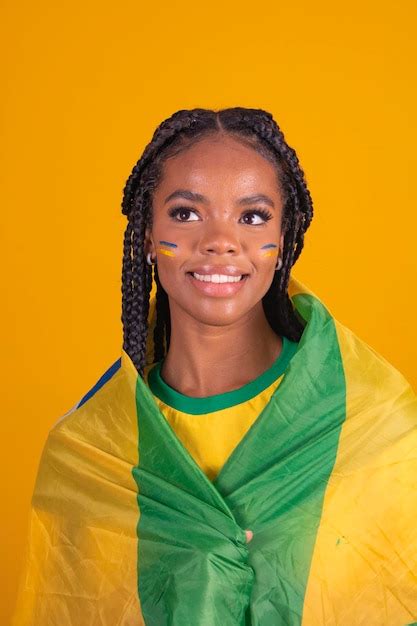 Premium Photo | Brazilian fan using paint as makeup brazilian fan celebrating football or soccer ...
