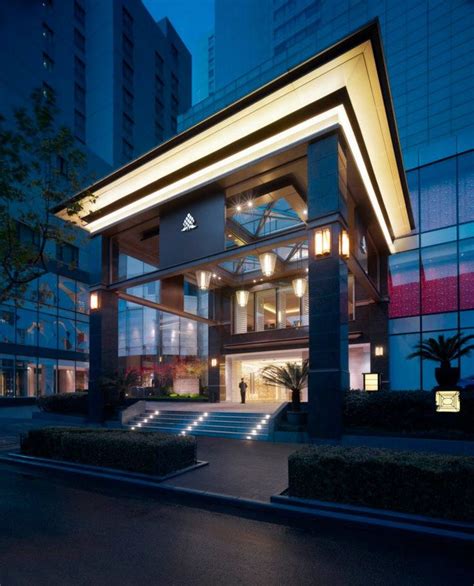 the entrance to a modern hotel at night