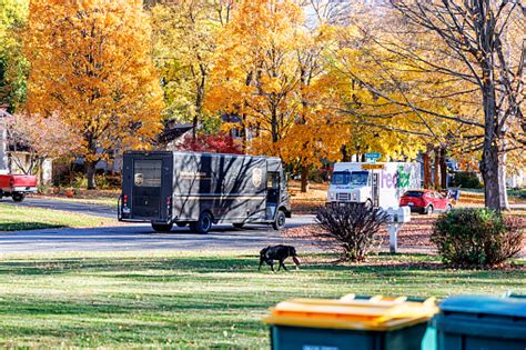 Fedex And Ups Delivery Trucks About To Pass On Suburban Street Stock Photo - Download Image Now ...