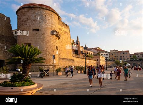 Alghero, Sardinia / Italy - 2018/08/10: Summer sunset view of the Alghero old town quarter with ...