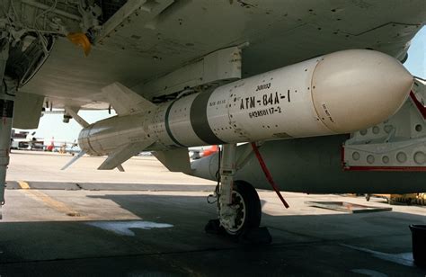 An AGM-84 Harpoon missile is fitted onto the fuselage of a U.S. Navy ...