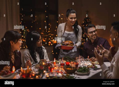 happy friends having christmas dinner at home Stock Photo - Alamy