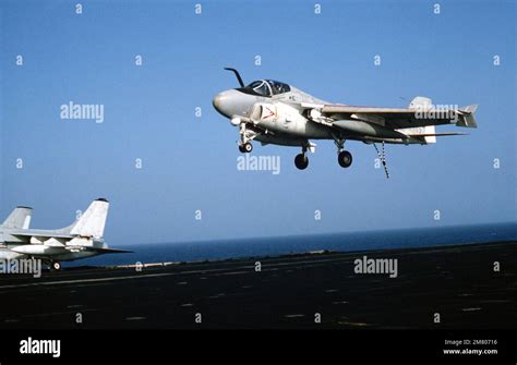 Right front view of an A-6 Intruder aircraft landing on the flight deck of the aircraft carrier ...