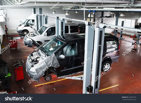 Industrial Car Lifting At Modern Repair Shop. Minibuses Service Maintenance At Professional ...