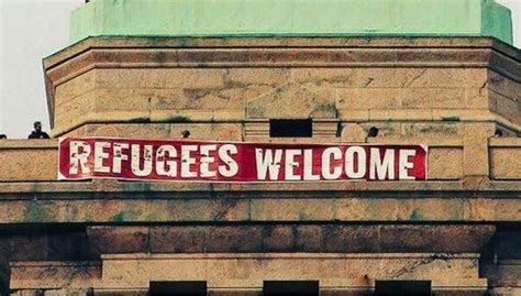 Activists Hang 'Refugees Welcome' Sign From The Statue of Liberty (PHOTOS)