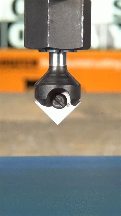 a close up of a machine tool on a piece of metal that is in the air
