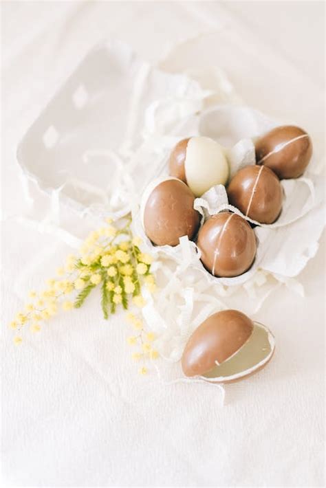 Crop Tray Of Brown Eggs With Flowers · Free Stock Photo