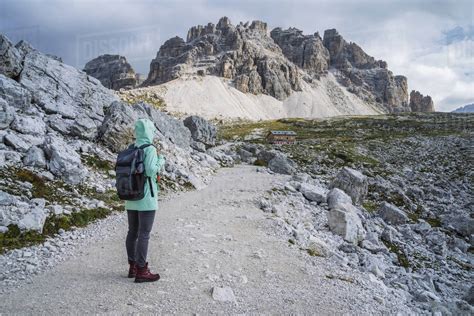 Woman with backpack hiking in Tre Cime National park. Dolomites, Italy, Europe - Stock Photo ...