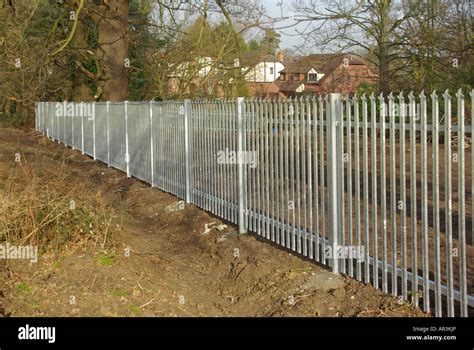 Galvanised steel palisade fence panels around paddock Stock Photo ...