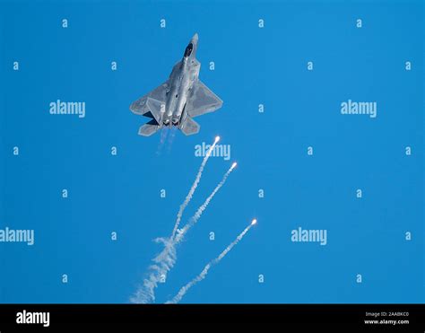 An F-22 Raptor fighter jet assigned to the 433rd Weapons Squadron pops flares during the ...