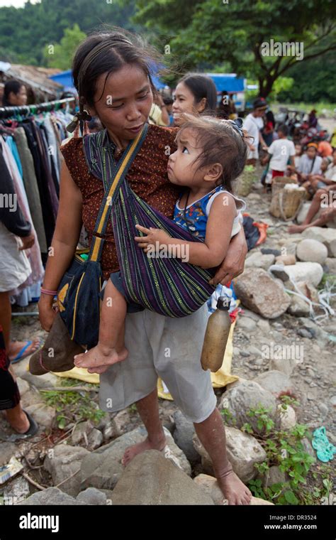 A Hanunoo Mangyan woman and her child shops at a Mangyan market near ...