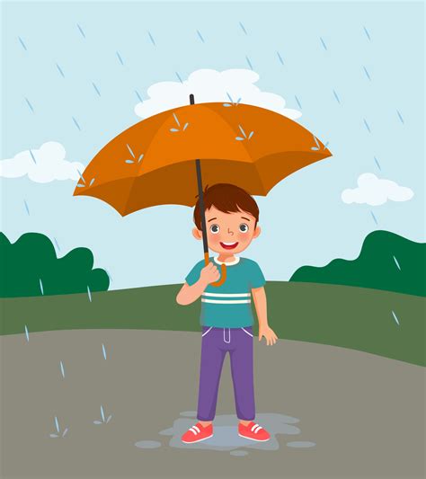 cute little boy holding umbrella in the rain on rainy day at the park ...