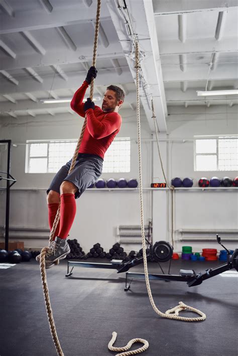 Fitness rope climb exercise at gym