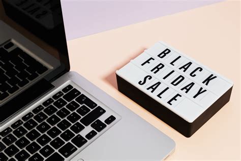 Macbook Pro Beside a Black Friday Sale Signage · Free Stock Photo