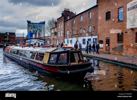 A canal boat on Birmingham Canal Old Line in the centre of the city of ...