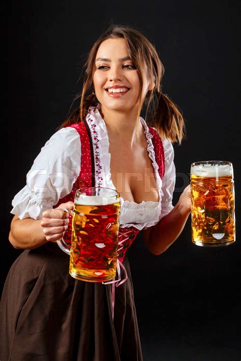 Oktoberfest server holding beer and smiling | Stock image | Colourbox