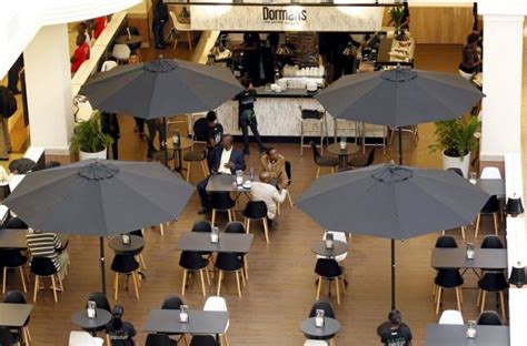 Customers sit inside the Dormans coffee shop at the reopened Westgate ...