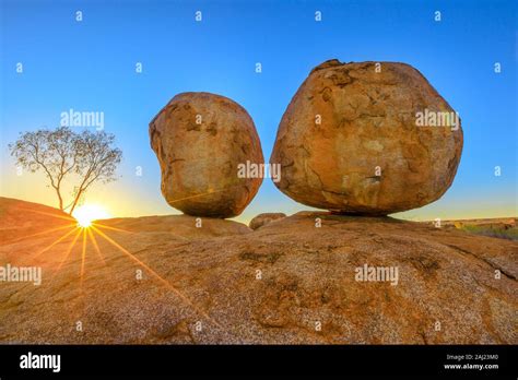 Sunset light rays at Devils Marbles, the Eggs of mythical Rainbow ...