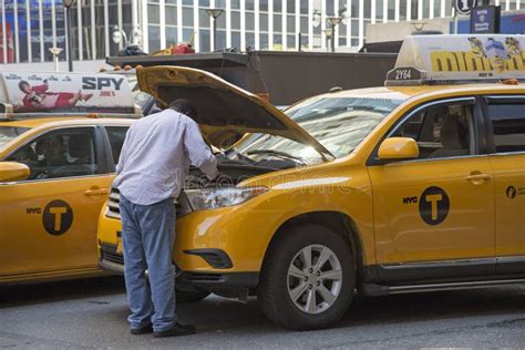 Yellow Cab Driver Looking at Engine of His Taxi Editorial Image - Image of open, male: 56265330