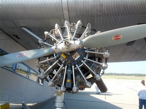 an airplane engine is attached to the side of it's wing as people look on