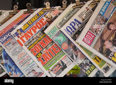 Greek newspapers on a clothesline in a newspapers shop of Piraeus ...