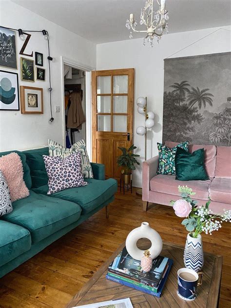 a living room filled with green couches and pink chairs next to a ...