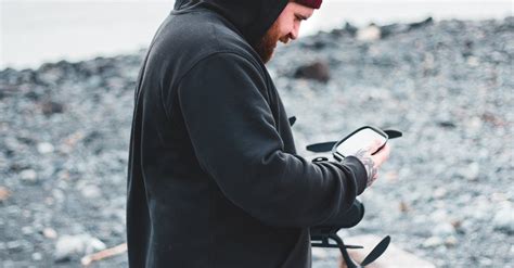 Man in Black Hoodie and Brown Shorts Holding Drone Camera · Free Stock Photo