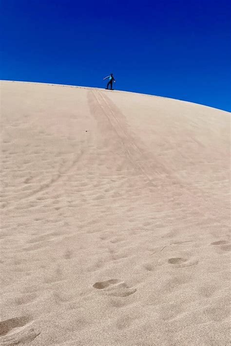 Sandboarding in Colorado (Great Sand Dunes) - Champagne Tastes®