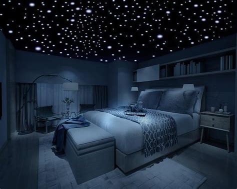 a bed room with a large bed under a sky filled with star shaped lights ...