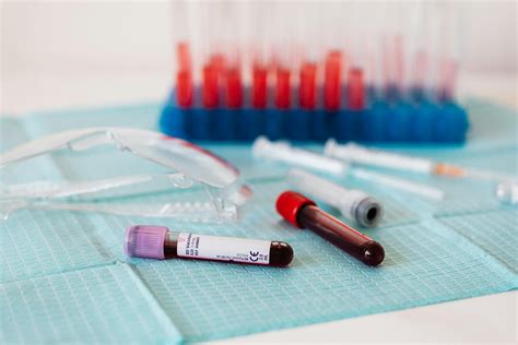 Full vials of blood near various medical equipment for taking blood · Free Stock Photo