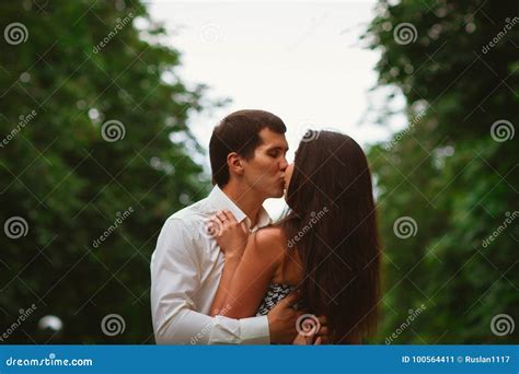 Beautiful Young Couple on a Nature Background Stock Image - Image of landscape, park: 100564411