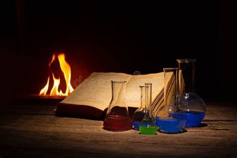 Medieval Alchemy and Pharmacy Concept with Old Book, Traditional Mask and Bottles with Medicine ...