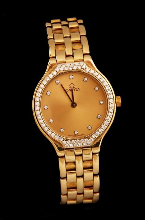 #53: LADIES' OMEGA DEVILLE 18K GOLD WATCH WITH DIAMONDS