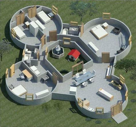 an aerial view of a circular house in the middle of a grassy area with ...