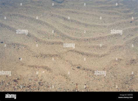 Sand shaped by waves underwater Stock Photo - Alamy