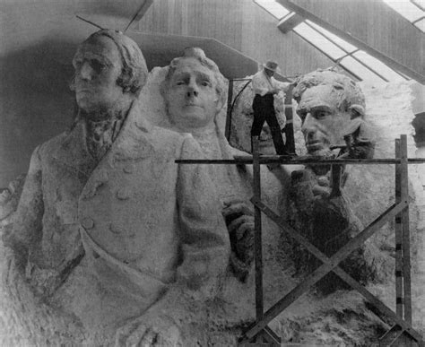 The sculptor of Mount Rushmore, Gutzon Borglum, with a model of the four presidents that ...